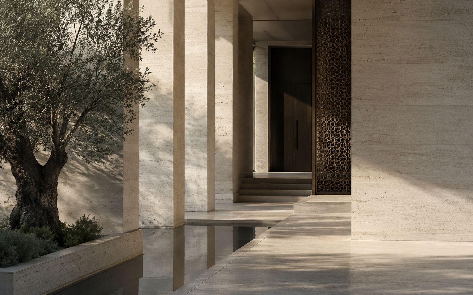 رواق حجري بمشربية برونزية في الرياض — a Riyadh limestone colonnade with a bronze screen